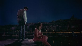 Movie still from “Fanny” (1961), directed by Joshua Logan – A man and a woman sitting on a dock at night; Wide shot, High angle