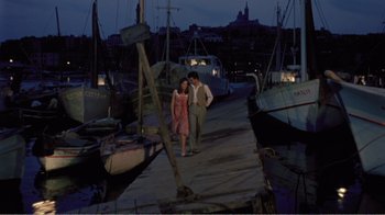 Movie still from “Fanny” (1961), directed by Joshua Logan – A man and a woman walking on a dock at night; Wide shot, High angle