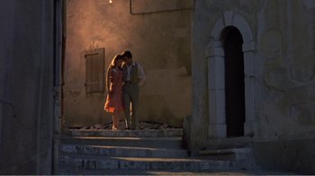 Movie still from “Fanny” (1961), directed by Joshua Logan – A man and a woman standing next to each other on steps; Wide shot, Low angle