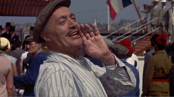 Movie still from “Fanny” (1961), directed by Joshua Logan – An older man wearing a hat and a striped shirt; Medium shot, Low angle