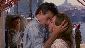 Movie still from “Fanny” (1961), directed by Joshua Logan – A man and a woman kissing in front of a boat; Medium shot, Over the shoulder angle
