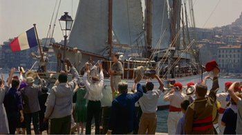 Movie still from “Fanny” (1961), directed by Joshua Logan – A group of people standing on top of a boat in the water; Extreme Wide shot, High angle
