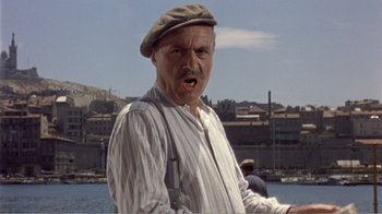 Movie still from “Fanny” (1961), directed by Joshua Logan – An older man wearing a hat and a striped shirt; Close Up shot, Low angle