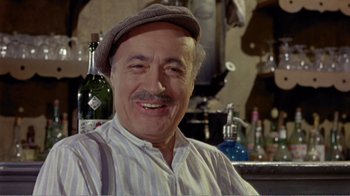 Movie still from “Fanny” (1961), directed by Joshua Logan – An older man wearing a hat in front of a bar; Close Up shot, High angle