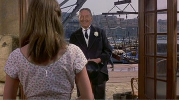 Movie still from “Fanny” (1961), directed by Joshua Logan – An older man wearing a suit and tie; Medium shot, Over the shoulder angle