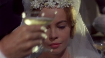 Movie still from “Fanny” (1961), directed by Joshua Logan – A woman holding a wine glass in front of her face; Close Up shot, Over the shoulder angle