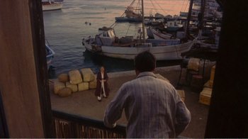Movie still from “Fanny” (1961), directed by Joshua Logan – A man sitting on a dock next to a body of water; Extreme Wide shot, High angle