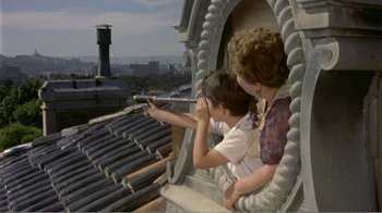 Movie still from “Fanny” (1961), directed by Joshua Logan – A woman and a boy looking out a window; Wide shot, High angle