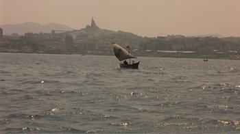 Movie still from “Fanny” (1961), directed by Joshua Logan – A small sail boat in the water; Extreme Wide shot, High angle