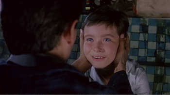 Movie still from “Fanny” (1961), directed by Joshua Logan – A young boy looking at his reflection in a mirror; Close Up shot, Over the shoulder angle