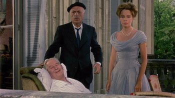 Movie still from “Fanny” (1961), directed by Joshua Logan – A group of people standing next to each other in a room; Medium shot, Low angle