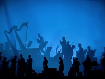 Movie still from “Fantasia” (1940), directed by Ford Beebe Jr. – Silhouetted orchestra musicians in a blue light; Extreme Wide shot, Low angle