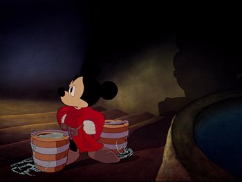 Movie still from “Fantasia” (1940), directed by Ford Beebe Jr. – A mickey mouse sitting on the ground with two wooden barrels; Wide shot, Low angle