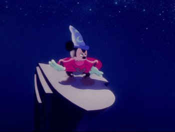 Movie still from “Fantasia” (1940), directed by Ford Beebe Jr. – A mickey mouse character sitting on top of a book; Wide shot, Low angle