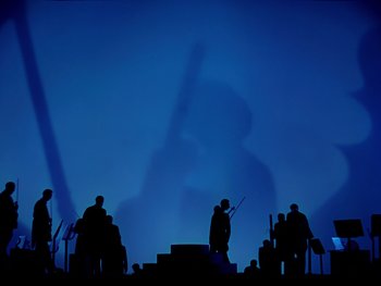 Movie still from “Fantasia” (1940), directed by Ford Beebe Jr. – Silhouetted figures in a dark blue background; Extreme Wide shot, Low angle