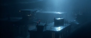 Movie still from “The Rock” (1996), directed by Michael Bay – A view of a building in the rain from the top of the stairs; Extreme Wide shot, High angle