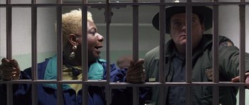 Movie still from “The Rock” (1996), directed by Michael Bay – Two people are talking in a jail cell; Medium shot, Low angle