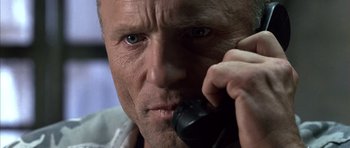 Movie still from “The Rock” (1996), directed by Michael Bay – A person talking on a cell phone; Close Up shot, Low angle