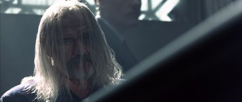 Movie still from “The Rock” (1996), directed by Michael Bay – An old man with long hair and a beard; Close Up shot, Over the shoulder angle