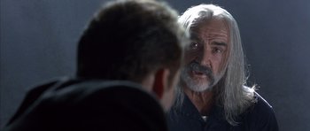 Movie still from “The Rock” (1996), directed by Michael Bay – An older man with long white hair looking in the mirror; Close Up shot, Over the shoulder angle