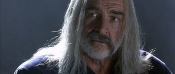 Movie still from “The Rock” (1996), directed by Michael Bay – An older man with long grey hair looking at the camera; Close Up shot, Low angle