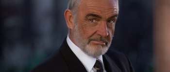 Movie still from “The Rock” (1996), directed by Michael Bay – An older man in a black suit and white tie; Close Up shot, Low angle