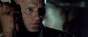 Movie still from “The Rock” (1996), directed by Michael Bay – A person wearing a black jacket; Close Up shot, Low angle