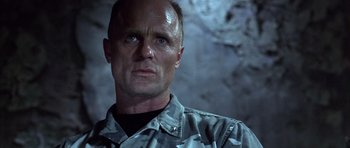 Movie still from “The Rock” (1996), directed by Michael Bay – A person wearing a camouflage shirt; Close Up shot, Low angle