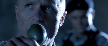 Movie still from “The Rock” (1996), directed by Michael Bay – A person holding an object in his mouth; Close Up shot, Low angle