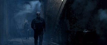 Movie still from “The Rock” (1996), directed by Michael Bay – A man walking down a dark alley way; Wide shot, Low angle