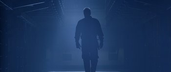 Movie still from “The Rock” (1996), directed by Michael Bay – A man walking in a dark room with a light shining on him; Wide shot, Low angle