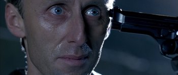 Movie still from “The Rock” (1996), directed by Michael Bay – A person with a mirror on his head; Extreme Close Up shot, Overhead angle