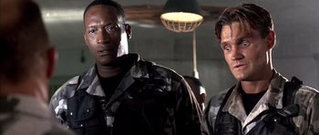 Movie still from “The Rock” (1996), directed by Michael Bay – Two men in military fatigues standing next to each other; Close Up shot, Low angle