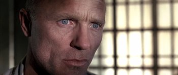 Movie still from “The Rock” (1996), directed by Michael Bay – A person's face with blue eyes; Extreme Close Up shot, Low angle