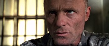 Movie still from “The Rock” (1996), directed by Michael Bay – A man's face in front of a window; Close Up shot, Low angle