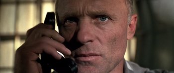 Movie still from “The Rock” (1996), directed by Michael Bay – A person talking on a cell phone; Close Up shot, Low angle