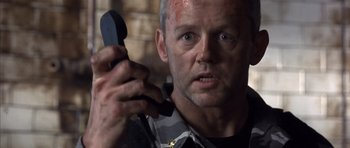 Movie still from “The Rock” (1996), directed by Michael Bay – A person holding a cell phone; Close Up shot, Low angle