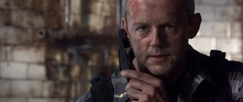 Movie still from “The Rock” (1996), directed by Michael Bay – A person holding a cell phone; Close Up shot, Low angle