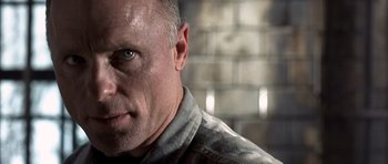 Movie still from “The Rock” (1996), directed by Michael Bay – A person with a beard; Close Up shot, Low angle