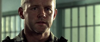 Movie still from “The Rock” (1996), directed by Michael Bay – A man's face in front of a window; Close Up shot, Low angle