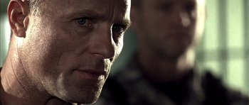 Movie still from “The Rock” (1996), directed by Michael Bay – A man's face in a dimly - lit room; Close Up shot, Low angle