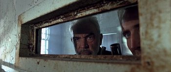 Movie still from “The Rock” (1996), directed by Michael Bay – An older man looking at himself in a mirror; Close Up shot, Low angle
