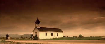 Movie still from “The Rock” (1996), directed by Michael Bay – An old white church sitting in the middle of a field; Extreme Wide shot, Low angle