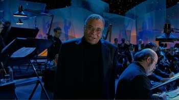 Movie still from “Fantasia 2000” (1999), directed by Eric Goldberg – An older man in a black suit standing in front of an audience; Medium shot, Low angle
