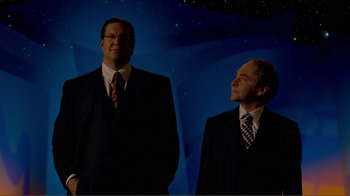 Movie still from “Fantasia 2000” (1999), directed by Eric Goldberg – A couple of men standing next to each other in suits; Medium shot, Low angle