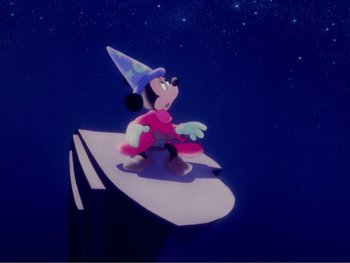 Movie still from “Fantasia 2000” (1999), directed by Eric Goldberg – A cartoon of mickey mouse sitting on top of a book; Extreme Wide shot, Low angle