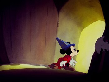 Movie still from “Fantasia 2000” (1999), directed by Eric Goldberg – A mickey mouse sitting on the ground in a room; Wide shot, Low angle