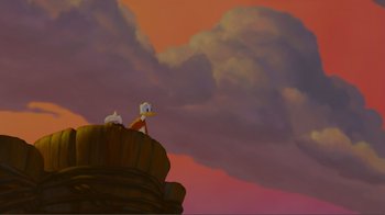 Movie still from “Fantasia 2000” (1999), directed by Eric Goldberg – A couple of animals sitting on top of a hill; Extreme Wide shot, Low angle