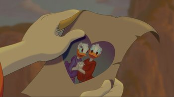 Movie still from “Fantasia 2000” (1999), directed by Eric Goldberg – A person holding a picture of two cartoon characters; Extreme Close Up shot, Overhead angle