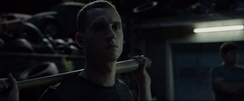 Movie still from “Fantastic Four” (2015), directed by Josh Trank – A man holding a baseball bat in a dark room; Close Up shot, Low angle